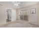 Sunlit bedroom features plush carpeting, sliding glass doors, and neutral paint at 1880 E Morten Ave # 125, Phoenix, AZ 85020