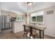 Bright dining area adjacent to the kitchen, featuring a modern table and ample sunlight at 1880 E Morten Ave # 125, Phoenix, AZ 85020