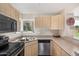 Functional kitchen featuring stainless steel appliances, practical counter space and natural light at 1880 E Morten Ave # 125, Phoenix, AZ 85020
