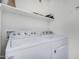 Bright laundry area with white washer and dryer and overhead shelf at 1880 E Morten Ave # 125, Phoenix, AZ 85020