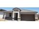 New construction home featuring a two-car garage and neutral-tone exterior with well defined lines at 18812 E Bruno Dr, Gold Canyon, AZ 85118