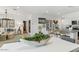 Bright living room with modern chandelier, open to kitchen featuring stainless steel appliances at 18812 E Bruno Dr, Gold Canyon, AZ 85118