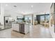Open-concept living space with a kitchen island, stainless steel appliances, and a comfortable living room at 18812 E Bruno Dr, Gold Canyon, AZ 85118