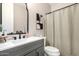 A bathroom featuring a shower with a shower curtain, modern vanity, and an elegant mirror at 20366 E Via De Colina --, Queen Creek, AZ 85142