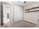 Empty bedroom featuring an attached bathroom, closet, shelving, carpeted floor, and neutral walls at 20366 E Via De Colina --, Queen Creek, AZ 85142