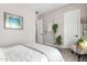 A well lit bedroom featuring a cool color pallet, neutral walls, and hanging plants at 20366 E Via De Colina --, Queen Creek, AZ 85142