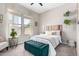 Charming bedroom featuring a large window, bench, light neutral colors, and ceiling fan at 20366 E Via De Colina --, Queen Creek, AZ 85142