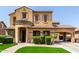 Charming two-story home with tile roof, arched entryway, and lush green landscaping at 20366 E Via De Colina --, Queen Creek, AZ 85142