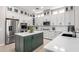 Kitchen with a large island, white cabinetry, stainless steel appliances, and marble countertops at 20366 E Via De Colina --, Queen Creek, AZ 85142