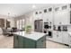 Kitchen with a green island, stainless steel appliances, and a dining area in the background at 20366 E Via De Colina --, Queen Creek, AZ 85142