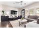 Comfortable living room with built-in cabinets, media console, and a large sectional sofa at 20366 E Via De Colina --, Queen Creek, AZ 85142