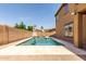 Private backyard oasis showcasing a sparkling pool with an umbrella, lounge chairs and sunny skies at 20366 E Via De Colina --, Queen Creek, AZ 85142