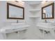 Modern bathroom with dual sinks, marble countertops, and stylish wood-framed mirrors at 2132 E Northview Ave, Phoenix, AZ 85020