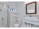 Well-lit bathroom with a glass shower, toilet, and a sink with marble countertops at 2132 E Northview Ave, Phoenix, AZ 85020