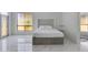 Modern bedroom with white walls, tiled floor, and a large window for lots of natural light at 2132 E Northview Ave, Phoenix, AZ 85020