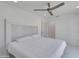 Bright bedroom with white walls, tiled floor, ceiling fan, and large headboard over the bed at 2132 E Northview Ave, Phoenix, AZ 85020