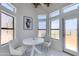 Cozy breakfast nook featuring white table and chairs, surrounded by natural light and charming decor at 2132 E Northview Ave, Phoenix, AZ 85020