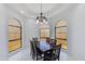 Elegant dining room featuring a large table, dark wood furniture, arched windows, and recessed lighting at 2132 E Northview Ave, Phoenix, AZ 85020