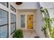 Inviting entryway featuring a decorative wooden door, side window, and elegant sconce lighting at 2132 E Northview Ave, Phoenix, AZ 85020