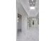 Bright hallway with white walls and tiled floors, with a skylight allowing for lots of natural light at 2132 E Northview Ave, Phoenix, AZ 85020