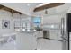 Modern kitchen with marble countertops, island seating, stainless steel appliances, and ample lighting at 2132 E Northview Ave, Phoenix, AZ 85020