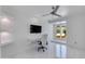 Bright home office with a built-in desk, shelving, and a view of the outdoor patio at 2132 E Northview Ave, Phoenix, AZ 85020