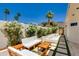 Stylish outdoor patio with lounge seating, palm trees and decorative stone at 2132 E Northview Ave, Phoenix, AZ 85020