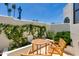 Outdoor patio with wooden table and chairs, surrounded by lush greenery and a serene atmosphere at 2132 E Northview Ave, Phoenix, AZ 85020