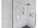 Sleek shower with marble tiling, built-in shelves, and modern fixtures at 2132 E Northview Ave, Phoenix, AZ 85020