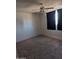 Carpeted bedroom features a ceiling fan and window with black curtains at 2179 E Palmcroft Dr, Tempe, AZ 85282