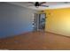 Bright living room with wood floors, a ceiling fan, and gray and yellow accent walls at 2179 E Palmcroft Dr, Tempe, AZ 85282