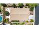 Aerial view of well-maintained roof with a stone patio, pool, and mature desert landscaping at 2507 E Eleana Ln, Gilbert, AZ 85298