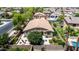 Lovely aerial view of backyard with a stone patio, and mature desert landscaping at 2507 E Eleana Ln, Gilbert, AZ 85298