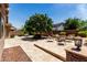 Spacious backyard featuring a large paver patio and mature shade tree at 2507 E Eleana Ln, Gilbert, AZ 85298