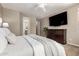 Bright bedroom featuring a comfortable bed, TV, and access to the ensuite bathroom at 2507 E Eleana Ln, Gilbert, AZ 85298