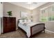 Comfortable bedroom with a bed, dresser, ceiling fan, and natural light from the window at 2507 E Eleana Ln, Gilbert, AZ 85298