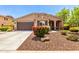 Charming single-story home featuring a well-manicured yard with colorful flowerbeds and a two car garage at 2507 E Eleana Ln, Gilbert, AZ 85298
