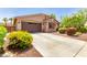 Inviting exterior showcasing a spacious driveway, lush landscaping, and a charming, well-maintained facade at 2507 E Eleana Ln, Gilbert, AZ 85298