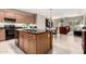 Well-equipped kitchen with stainless steel appliances, granite countertops, and an island with a sink at 2507 E Eleana Ln, Gilbert, AZ 85298