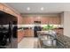 Gourmet kitchen boasts stainless steel appliances, granite counters, and ample cabinet space at 2507 E Eleana Ln, Gilbert, AZ 85298