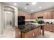 Modern kitchen featuring granite countertops, wood cabinetry, and stainless steel appliances at 2507 E Eleana Ln, Gilbert, AZ 85298