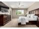 Relaxing main bedroom with a ceiling fan, two dressers, and a window at 2507 E Eleana Ln, Gilbert, AZ 85298