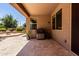 Outdoor patio area with a grill, seating, and lush green landscaping at 2507 E Eleana Ln, Gilbert, AZ 85298