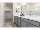 Spacious bathroom with double sinks, gray cabinets, and a walk-in closet at 300 N Gila Springs Blvd # 181, Chandler, AZ 85226