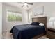 Bright bedroom featuring wood floors, a ceiling fan, and a large window at 300 N Gila Springs Blvd # 181, Chandler, AZ 85226