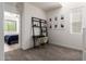 Cozy room with ladder shelf, gallery wall, neutral carpet, and view of bedroom beyond at 300 N Gila Springs Blvd # 181, Chandler, AZ 85226