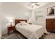 Bedroom features a wooden bed frame, bedside tables with lamps, and a window with plantation shutters at 300 N Gila Springs Blvd # 181, Chandler, AZ 85226