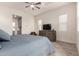 Bright bedroom showcasing wood floors, a ceiling fan, and a gray dresser at 300 N Gila Springs Blvd # 181, Chandler, AZ 85226
