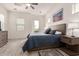 Bright bedroom with wood floors, ceiling fan, and access to a balcony at 300 N Gila Springs Blvd # 181, Chandler, AZ 85226