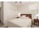 Bright bedroom with a wooden bed frame, bedside tables with lamps, and a sliding closet door at 300 N Gila Springs Blvd # 181, Chandler, AZ 85226